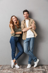full length portrait of a cheerful young couple standing