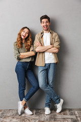 Wall Mural - Full length portrait of a happy young couple standing
