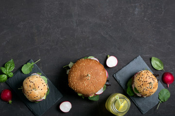 Veggie falafel burgers with fresh vegetables on dark background