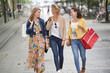 © goodluz - Cheerful women shopping together in town