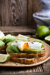 Canvas Print - Poached egg and sliced avocado on whole wheat bread toast