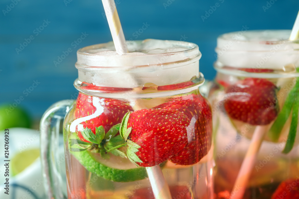 Mason jar with tasty strawberry lemonade, closeup