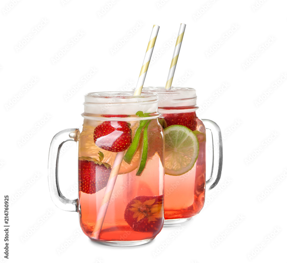 Mason jars with tasty strawberry lemonade on white background
