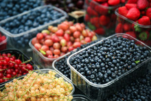 Containers With Different Ripe Berries At Market