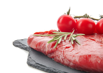 Slate plate with fresh raw meat, rosemary and tomatoes on white background