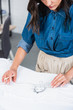© LIGHTFIELD STUDIOS - cropped image of female fashion designer measuring print on t-shirt by ruler