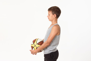 Wall Mural - teenager with a basketball on a white background.