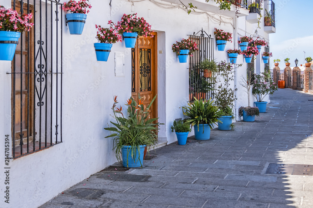 Beautiful view of old Mijas Calle Moro (Moro Street). Mijas (not far from Malaga) - Spanish hill town overlooking the Costa del Sol, known for its white-washed buildings. Mijas, Andalusia, Spain. - obrazy, fototapety, plakaty 