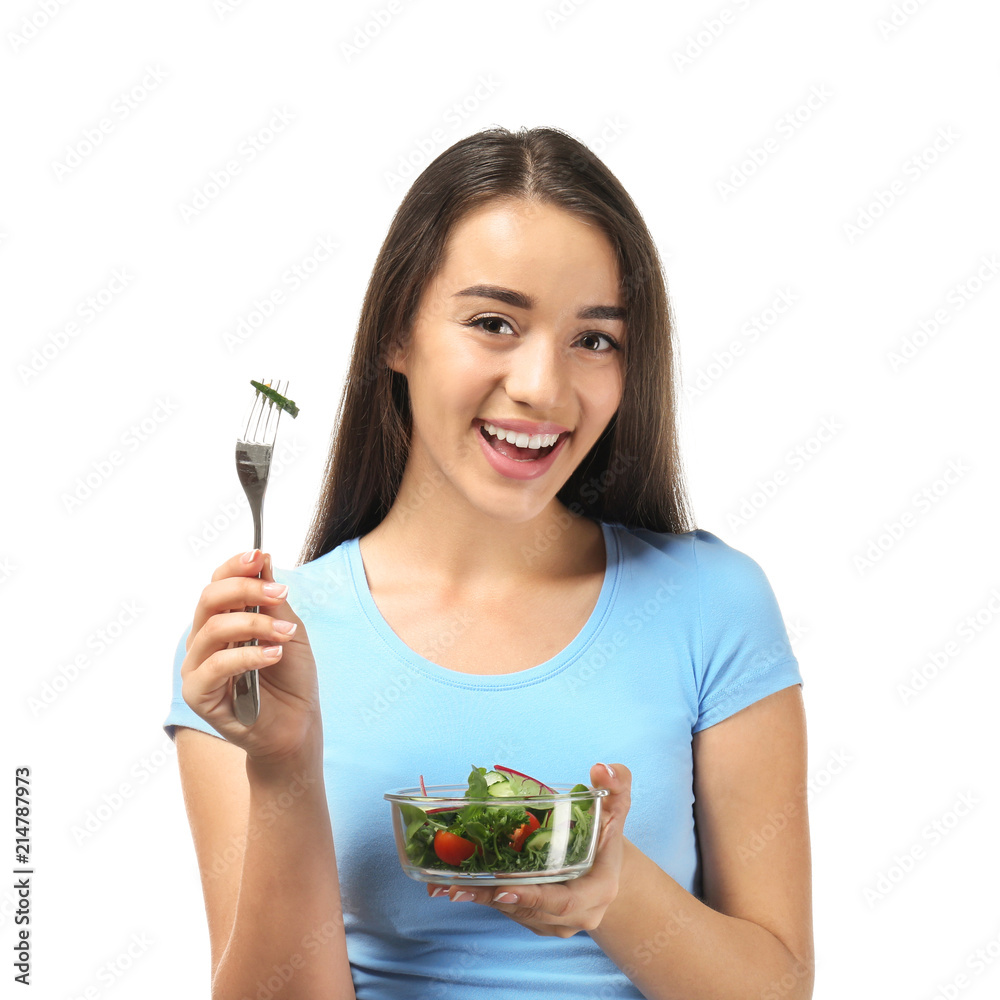 Young woman with healthy vegetable salad on white background