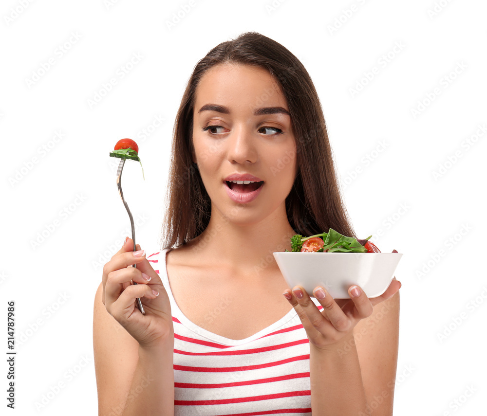 Young woman with healthy vegetable salad on white background