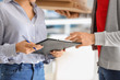 © Pixel-Shot - Woman signing document to confirm receipt of order from food delivery company