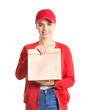 © Pixel-Shot - Young woman with paper bag on white background. Food delivery service