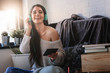 © lordn - Beautiful young woman at home enjoys listening music through headphones