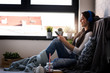 © lordn - Beautiful young woman at home enjoys listening music through headphones