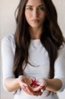 © lordn - Woman holding red ribbon on her palms. AIDS awareness symbol