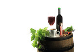 Fototapeta  - Butelka czerwonego wina i kawa w świetle świecy na beczce z winogronem.