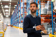 © Stock Rocket - Manager in warehouse holding digital tablet