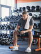 © Erik Isakson/Tetra Images - Mid adult man with towel and bottle in gym