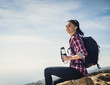 © Erik Isakson/Tetra Images - Woman with water bottle sitting on rock