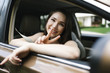 © Jessica Peterson/Tetra Images - Smiling young woman doing peace sign in car