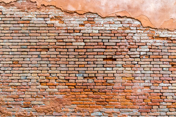 Wall Mural - Old and damaged orange brown brick wall