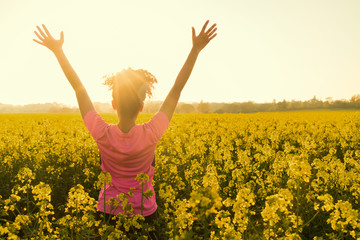 female woman athlete runner celebrating in yellow flowers
