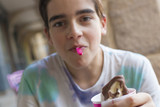 Fototapeta Na ścianę - young man eating ice cream on the summer terrace