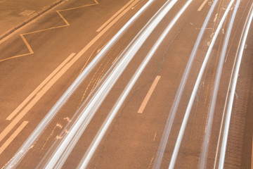 Road at night with long exposure and traces of automobile headlights.