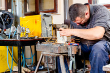 Artist Is Making Figure By Welding Few Metal Wires In His Workshop, Barehanded