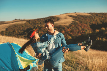 Wall Mural - Happy young couple enjoys a sunny day in nature