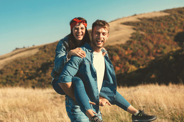 Wall Mural - Happy young couple enjoys a sunny day in nature