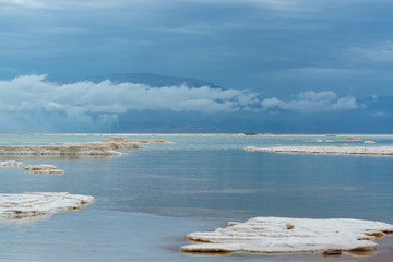 Lowest salty lake in world below sea level Dead sea, full of minerals near vacation resort Ein Bokek, perfect place for medical treatments, climatotherapy, thalassotherapy and heliotherapy.