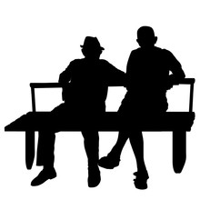 Two Elderly People Silhouettes Sitting On A Park Bench