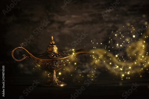 Fotografia Image of magical mysterious aladdin lamp with glitter sparkle smoke over black background
