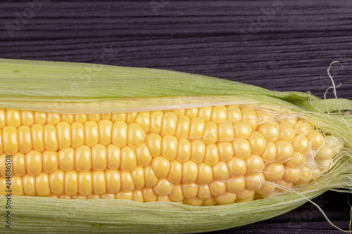 cob  corn on a black wooden background