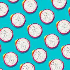 Wall Mural - dragonfruit creative tropical pattern vivid blue background. abstract summer art background. minimal