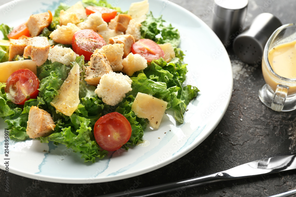 Tasty Caesar salad on plate, closeup