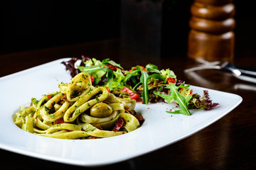 Sticker - Tasty dish with pasta and juicy meat in the white on the table i