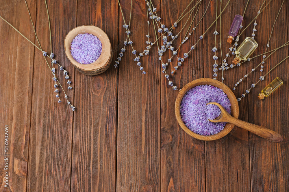 Spa composition with beautiful lavender and sea salt on wooden table