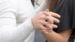 © Stavros - Close-up image of a young couple holding hands.