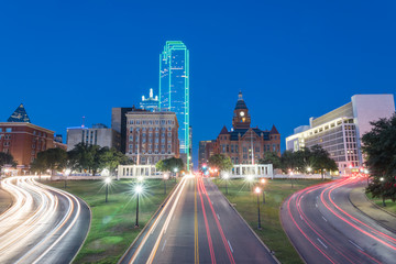 Wall Mural - Beautiful view of Dallas skyscrapers and light trail traffic over Dealey Plaza, JKF assassination site. Skyline and transportation cityscape at blue hour