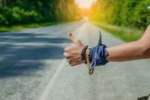 Teenager Hitchhiker Holding Hand Gesture To Stop A Car. Close-up