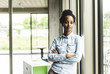 © Westend61 - Confident young businesswoman leaning on window in modern office