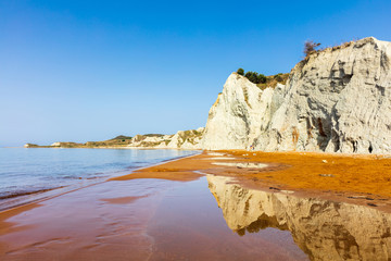 Beach with orange sand and white rocks