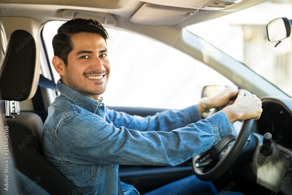 Attractive man driving a car - obrazy, fototapety, plakaty 