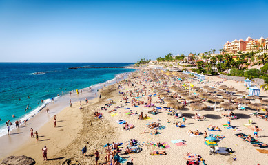 Wall Mural - People sunbathing on the El Duque beach. Tenerife. Spain