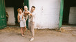 © LIGHTFIELD STUDIOS - woman standing near husband with adorable little baby on hands at countryside