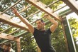 © Wavebreak Media - Fit man climbing monkey bars