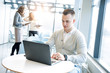 © Kseniia - Handsome businessman working with laptop in office