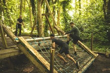 Fit Mens Training Over Obstacle Course